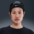 Nike Swoosh Classic headband worn by a young woman, showcasing its comfortable and stylish design in black.