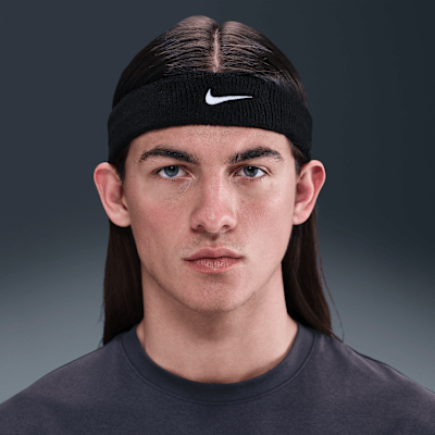 Nike Swoosh Classic headband on a young man, showcasing its moisture-wicking terry cloth fabric.