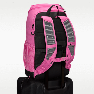 Nike Varsity Elite backpack in Playful Pink attached to luggage trolley for easy travel.